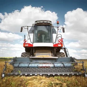 Tractor harvesting crops over the farm